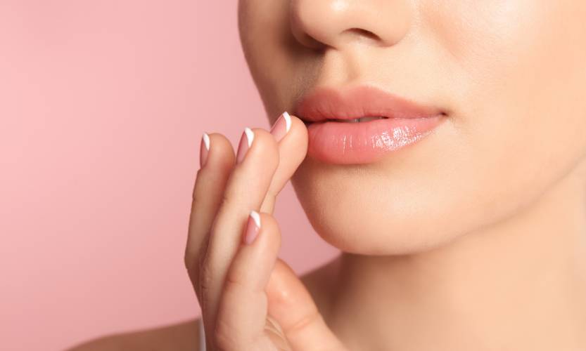 woman touching her pink lips 