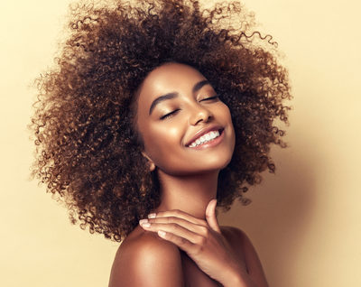 black woman with natural hair and beautiful smile